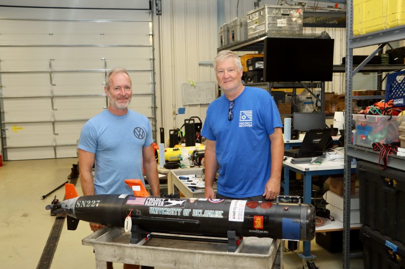 Erik White, left, and Dr. Mark Moline stand in the lab at the University of Delaware’s Hugh R. Sharp Campus in Lewes. An autonomous underwater vehicle named the Bipolar is in the foreground. The drone helped them locate a WWII aircraft that was shot down in 1945 near an Island in Micronesia. White and Moline are part of the nonprofit group Project Recover, which searches for the 80,000 aircraft and crew remains still missing from WWII. BILL SHULL PHOTOS